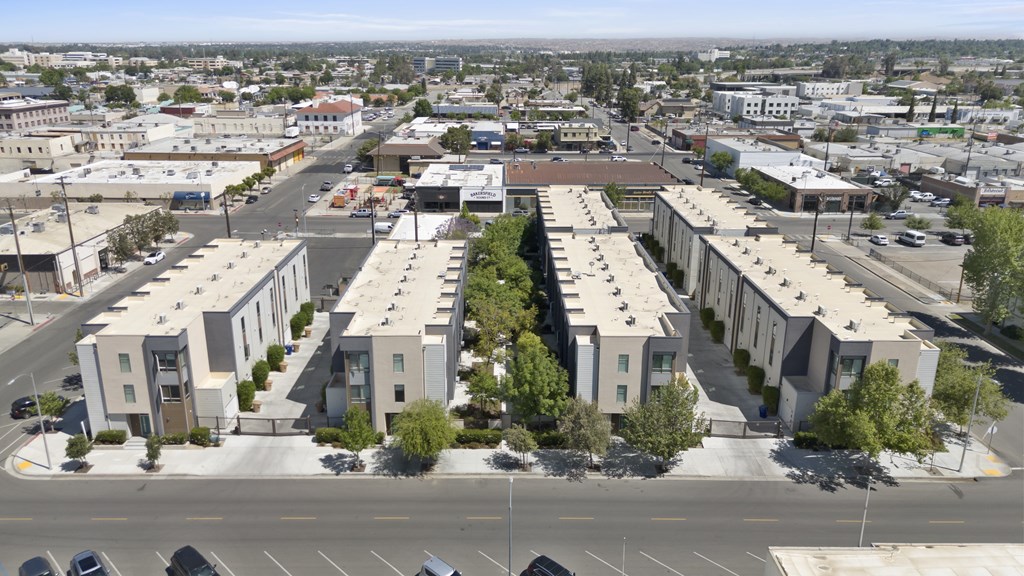 A view of a city with apartment buildings and cars.